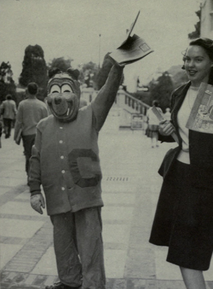 Archival scan: Oski beside a person holding a megaphone. Photo credit: Photographer/artist uncredited in supplied scan.