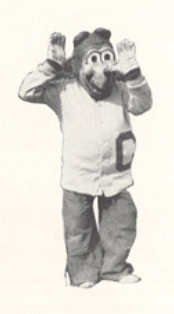 Archival scan: Oski waving both hands beside his head. Photo credit: Photographer/artist uncredited in supplied scan.