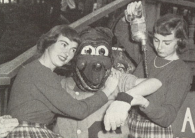 Archival scan: Oski posing with two people during a blood-donation scene. Photo credit: Photographer/artist uncredited in supplied scan.
