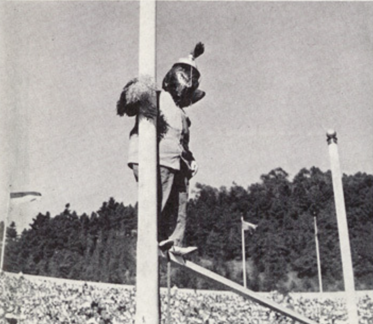 Archival scan: Oski balancing on a goalpost. Photo credit: Photographer/artist uncredited in supplied scan.