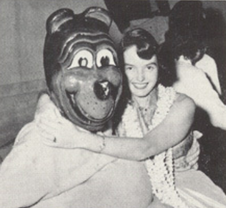 Archival scan: Oski embracing a woman for a photo. Photo credit: Photographer/artist uncredited in supplied scan.
