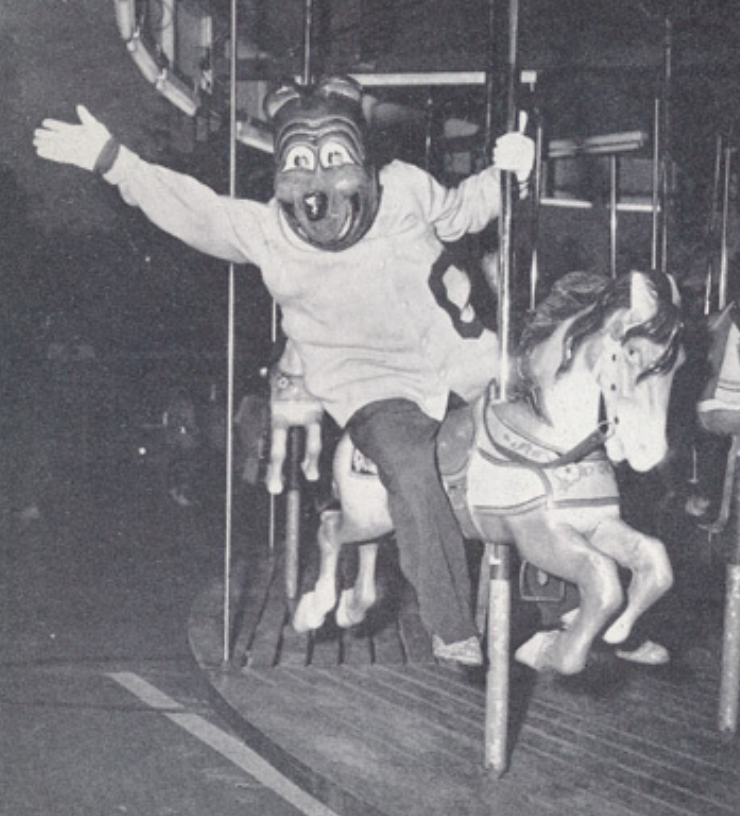 Archival scan: Oski riding a carousel horse. Photo credit: Photographer/artist uncredited in supplied scan.