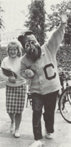 Archival scan: Oski waving beside a young visitor. Photo credit: Photographer/artist uncredited in supplied scan.