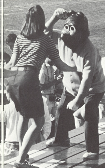 Archival scan: Oski dancing with a woman on stadium steps. Photo credit: Photographer/artist uncredited in supplied scan.