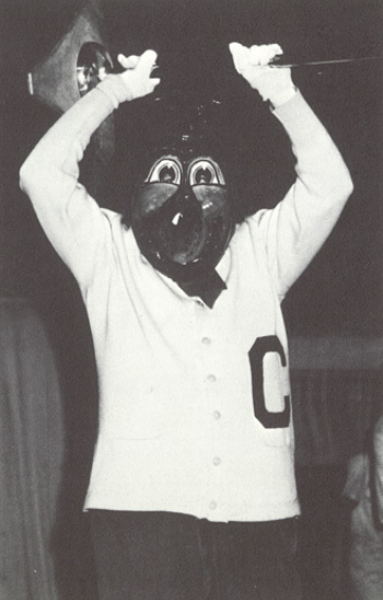 Archival scan: Oski lifting a microphone stand above his head. Photo credit: Photographer/artist uncredited in supplied scan.