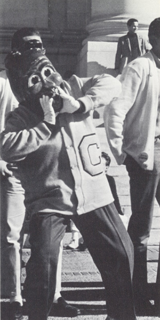 Archival scan: Oski standing with another mascot during a birthday scene. Photo credit: Photographer/artist uncredited in supplied scan.