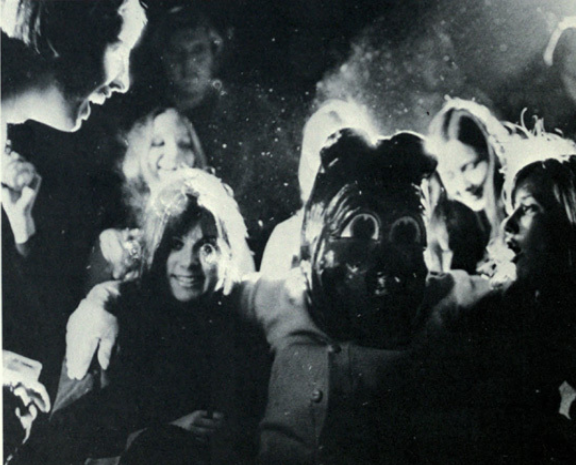 Archival scan: Oski seated among fans. Photo credit: Photographer/artist uncredited in supplied scan.