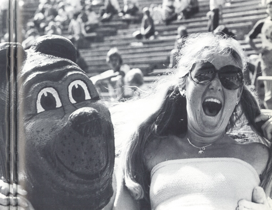 Archival scan: Oski beside an excited spectator in the stands. Photo credit: Photographer/artist uncredited in supplied scan.