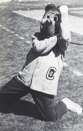 Archival scan: Oski leaping with one arm raised. Photo credit: Photographer/artist uncredited in supplied scan.