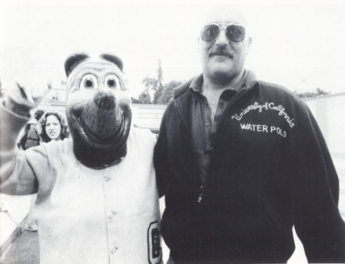 Archival scan: Oski posing with a water polo team member. Photo credit: Photographer/artist uncredited in supplied scan.