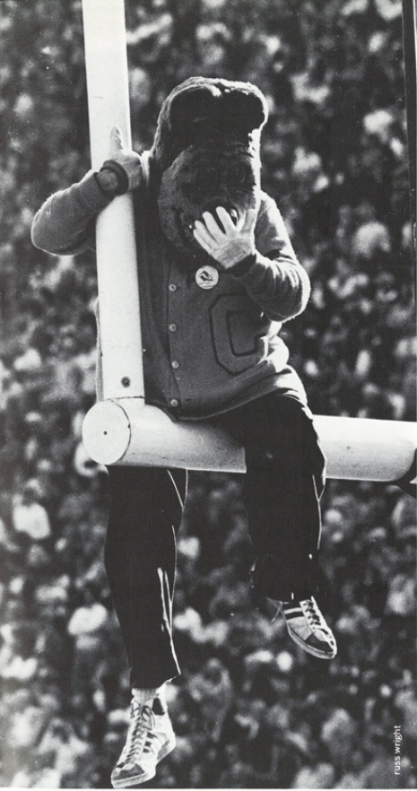 Archival scan: Oski hugging a goalpost. Photo credit: Photographer/artist uncredited in supplied scan.